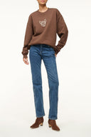 Brown oversized sweatshirt with small dog face graphic on chest
