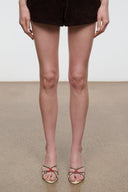 Mule sandals worn: cream uppers with red bows and low block heel.