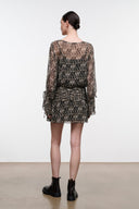 Speckled black and brown mini dress with sheer long sleeves, waist belt, and ruffled cuffs