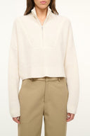 Ivory cropped cashmere sweater with quarter-zip and ribbed cuffs