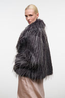 Dark gray shag fur jacket on model, side view, open front