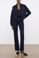 Indigo denim jacket with button front, chest flap pockets, and long sleeves