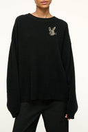 Black cashmere crewneck sweater with butterfly applique at chest