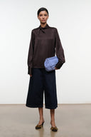 Espresso brown mule shoes with low heel and decorative toe trim, worn with culottes