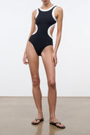 Black and white sleeveless one-piece swimsuit with contrast white trim at neckline and leg openings