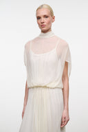 Ivory mock-neck maxi dress with draped sheer yoke and gathered waist