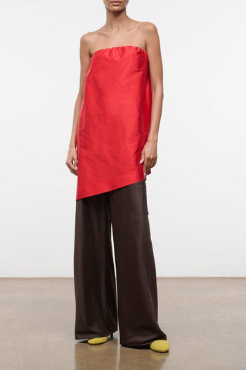 Red strapless convertible silk dupioni top with draped neckline and asym hem