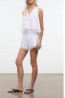 White sleeveless romper short with lace trim and scalloped hem