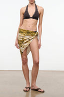 Silk scarf wrap in gold and green abstract print, tied around the waist