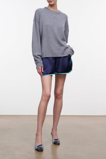 Navy athletic shorts with teal trim and elastic waistband