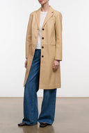 Cashew beige leather trench coat with notched lapels, button front, and side pockets