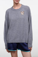 Ash gray cashmere crewneck sweater with embroidered dog crest; ribbed hem and cuffs