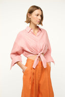 Faded blush linen button-up top with tied waist, pointed collar, and flared sleeves