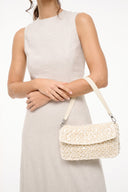 Cream woven crossbody shoulder bag with flap and metal hardware