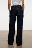 Indigo wide-leg jeans with rear yoke and stitched belt loops, back patch pockets