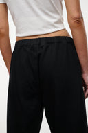 Black jeans with gathered elastic waistband and relaxed straight-leg cut