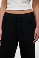 Black wide-leg jeans with side pockets and elastic waistband, close-up