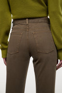 Straight jeans close-up in dark brown, front pockets, belt loops, button fly