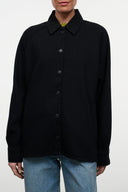 Black shirt jacket with pointed collar and centered button placket, long sleeves