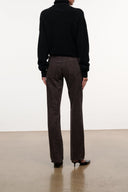 Back view of straight leg dark brown leopard-print jeans with mid-rise waist and seams