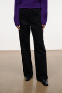 Relaxed black jeans close-up on front with wide leg opening
