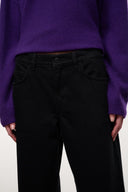 Black denim jeans front view with button closure and coin pocket