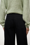 Black jeans with patch-style pockets and contrast stitching on waistband