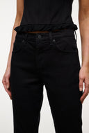 Black denim jeans with button front, belt loops, and ruffle waistband trim