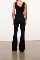 Black wide-leg denim jeans with smocked back yoke and button closure