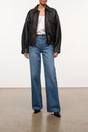 High-rise vintage wash jeans with embellished crystal belt at waistband and wide straight legs