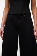 Jet black barrel-leg jeans with button-front and side pockets