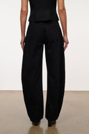 Jet black barrel-leg jeans with relaxed fit and center crease