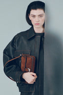<p>Crafted in tabac suede, the Harlow Bag leans into luxurious texture while keeping its polished shape.</p>