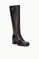 Side view of knee-high dark leather boots with metal buckle and block heel