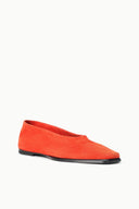 Orange suede flat slip-on shoes with curved toe and black sole