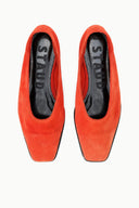 Orange suede flat slip-on shoes, top view showing interior lining
