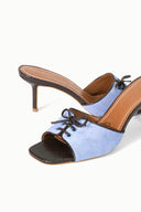 Light blue suede mule sandal close-up, lace-up vamp, textured dark outsole