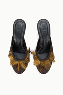 Pair of espresso brown mules with gold feather-trim and black interior lining