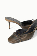 Distressed mule with pointed toe, slim heel, and lace-up bow detail at the vamp