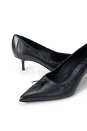 Black leather kitten heel pump close-up of bow and stitched upper
