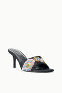 Black heeled mule with colorful circular bead embroidery on upper, angled view
