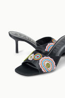 Black heeled mule close-up: colorful bead mosaic embroidery on front strap