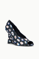 Front-side view of peep-toe wedge heel in dark floral patterned fabric