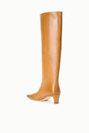 Cashew distressed knee-high boot with low block heel and sleek pointed toe