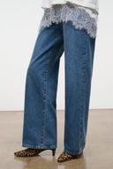 Cheetah-print ankle boots with low heel, front view with blue jeans