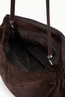 Oversized brown suede bag interior with drawstring top and zip pocket