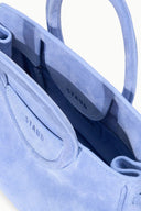 Light blue mini carryall handbag open interior with logo patch and fabric lining