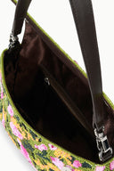 Interior of woodland print convertible shoulder bag with dark lining and zipped compartment