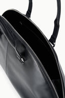 Black satchel bag interior with zip pocket, zipper track, and metal pull