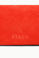 Orange suede-like shoulder bag panel with embossed “STAUD” logo